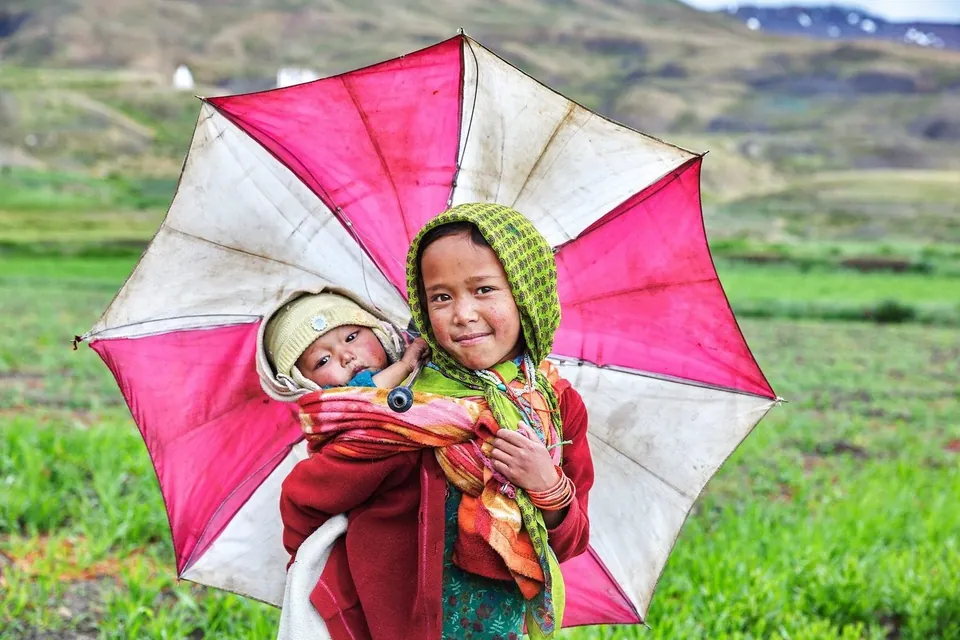 A child holding a colourful umbrella in Hikkim, Spiti